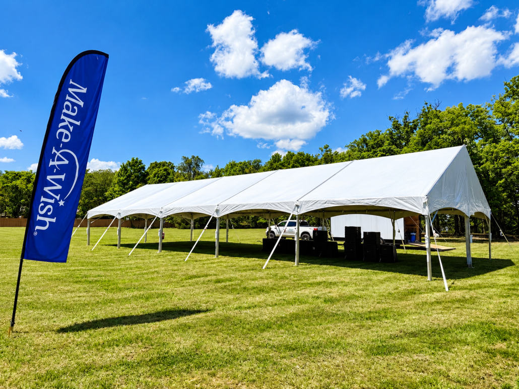 30x75 Gable end Tent Tent setup in a field for an event